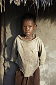 SOUTH SUDAN  Early morning scene on a farm homestead of Yei  Young girl catching the first rays of the sun