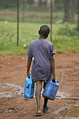 UGANDA  Boy carrying water  Village of Kayunga District