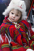 Young Sami (Lapp) girl in traditional clothes. Jokkmokk, Northern Sweden