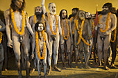 Naga Sadhus preparing for bathing in The holy river Ganges at Kumbh Mela Festival. Allahabad, Uttar Pradesh, India