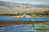 Gilimanuk, Bali, Indonesia. Bay with boat & children