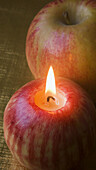 candle in the shape of apples and apple