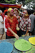 Panjim Goa, India, men putting colored powder on their faces during the Holi feast