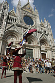 Siena Italy, flag-weavers of the Contrada della Torre in front of the Dome during the Palio