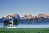 St. Coloman church in morning mist, near Schwangau, Allgaeu, Bavaria, Germany