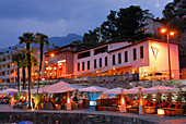 Bar under sun shades on the illuminated seaside promenade in Ascona, Ascona, lake Maggiore, Lago Maggiore, Ticino, Switzerland