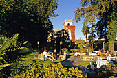 People at the park in front of Hotel Castello in the sunlight, Ascona, Lago Maggiore, Ticino, Switzerland, Europe