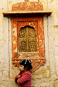 A cute Indian kid plays next to his home in the Old city of Jaisalmer, Rajasthan, India