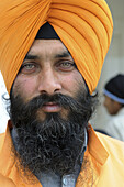 Portrait of a beautiful Sikh man (he is one of the guards in the entrance to the holy Golden temple) in Amritsar, India