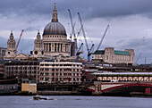St. Paul's cathedral and harbour cranes, London. England, UK
