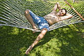 Young man relaxing in a hammock
