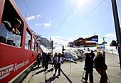 Skiers exiting a narrow-gauge railroad, Diavolezza, Engadin, Grisons, Switzerland