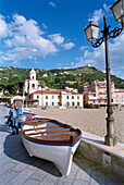 Beach and promenade with boat, Santa Maria di Castellabate, Castellabate, Cilento, Italy