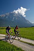 Couple on a mountain bike tour near Obermieming, near Telfs, Mieminger Plateau, Tyrol, Austria