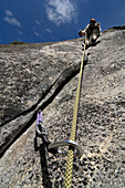 Woman rock climbing in Yosemite National Park, California, USA