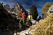 Mature couple mountain hiking, Dolomite Alps, Sëlva, Trentino-Alto Adige/Südtirol, Italy