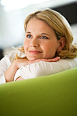 Woman lying happily on couch
