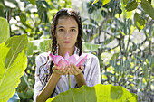 17-19, Beauty, Body care, Casual, Caucasian, Clothing, Color, Colour, Contemporary, Flower, Fragility, Freshness, Green, Head & shoulders, Head and shoulders, Health, Holding, Leaf, Looking at camera, Lotus, One person, Outdoors, Pink, Portrait, Rain, Sho