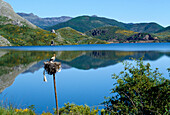 View over lake with stork's nest to Picos de Europa mountains, Embalse de Riano, Cantabria, Spain
