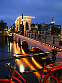 Bicycle near the Skinny Bridge at night, Amsteram, Noord Holland Province, Netherlands