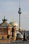 Chimney sweeps standing on roof, dome of New Synagogue, in background, Berlin, Germany