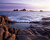 View of Corbiere Lighthouse across rockpool at sunset, Corbiere Point, Jersey, UK, Channel Islands