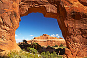 Red rock formation framed by Tunnel Arch, Arches National Park, Utah, USA