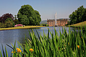 View over lake with irises to house, Chatsworth House, Derbyshire, UK, England