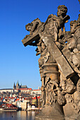 Statue on Charles Bridge and view to Castle, Prague, Czech. Republic
