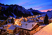 Town and Dolomites at night in winter, Arabba, Trentino-Alto Adige, Italy