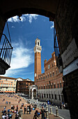 Piazza del Campo with Torre del Mangia, view through arch, Siena, Tuscany, Italy