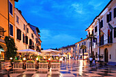 Cafe scene at night, Lazise, Lombardy, Lake Garda, Italy