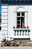 Detail of wooden house with bicycle and window box, Rauma, Finland