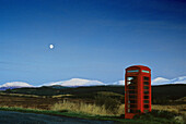 Red telephone box in front of the snow-covered Grampian Mountains, Highlands, Grampian, Scotland, Great Britain, Europe