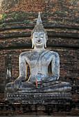 Sitting Buddha in front of chedi at Wat Mahathat, Sukothai Historical Park, Central Thailand, Asia