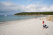 People on a sandy beach in the sunlight, Porto Pino, Sardinia, Italy, Europe
