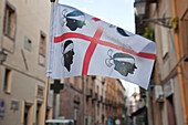 Flag of Sardinia amidst the houses of the Old Town, Bosa, Sardinia, Italy, Europe