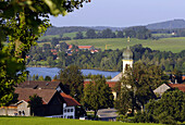 Blick auf Froschhausen mit Kirche St Leonhard am Riegsee, Bayern, Deutschland