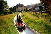 Touristen auf der Sommerrodelbahn in Karpacz, Riesengebirge, Nieder-Schlesien, Polen, Europa