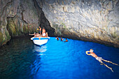 Tourist in the blue grotto, Cape Palinuro, Cilento, Campania, Italy