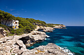 Cliffs in the bay Cala Mondragó under blue sky, natural park of Mondragó, Mallorca, Balearic Islands, Mediterranean Sea, Spain, Europe
