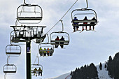 Skiers on chairlifts. La Molina ski resort,  Girona province,  Catalonia,  Spain