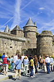 Tourists in front of ramparts of medieval castle (13th century),  Fougères. Ille-et-Vilaine,  Bretagne,  France