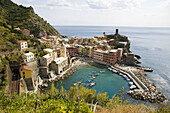 Italy,  Cinque Terre,  Vernazza.  Small town on the Italian Riviera.  One of the five villages on the famous Cinque Terre hiking trail.  Viewed from the trail on the cliffs above.