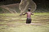 Cambodian fisherman with fishing net in a river, Angkor, Siem Reap Province, Cambodia, Asia