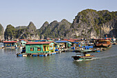 Colourful houses in the sunlight, floating fishing village at the Halong Bay at the Gulf of Tonkin, Vietnam, Asia