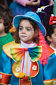 Girl dressed up as a clown at Carnival, Funchal, Madeira, Portugal