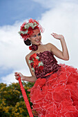 Woman with dress full of red roses at the Madeira Flower Festival Parade, Funchal, Madeira, Portugal