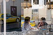 Two women in a cafe, window reflection, Ribeira Brava, Madeira, Portugal