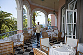 Waiter serves Afternoon Tea on the Terrace at Reid's Palace Hotel, Funchal, Madeira, Portugal